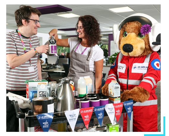 Air Ambulance UK tea trolley with bear mascot and 2 colleagues