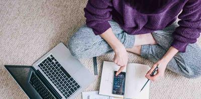 woman sat on floor completing paperwork