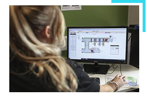 Building operations employee looking at building plans on computer