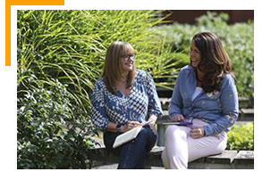 2 employees outside chatting