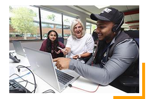 3 employees discussing and looking at computer