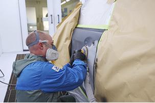Ageas supplier Akzo Nobel employee repairing a vehicle