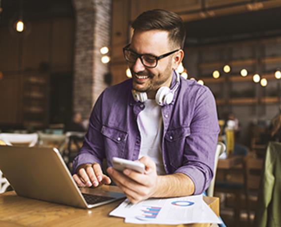 man in coffee shop on laptop