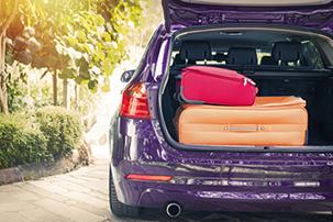 Purple car with luggage in the boot