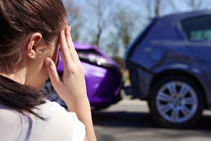 Woman on the phone and woman on the phone in the background after a traffic collision