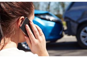 Woman on the phone and woman on the phone in the background after a traffic collision