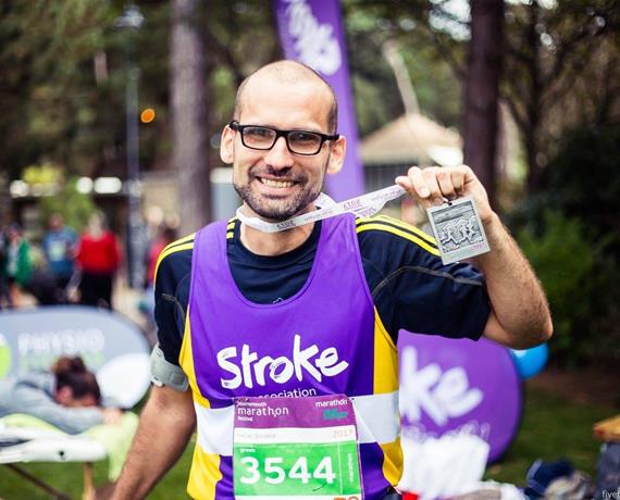Ageas employee on charity run with medal