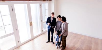 Asian family at house viewing with estate agent