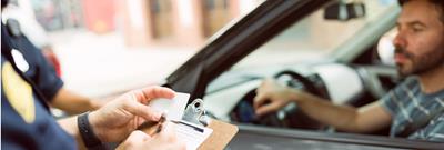 police officer stops driver with clipboard