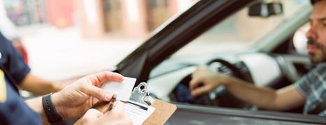 police officer stops driver with clipboard