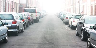street lined with parked cars on both sides