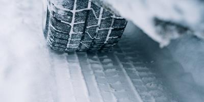 Car tyre rolling over snow