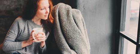 woman sitting in warm home during winter