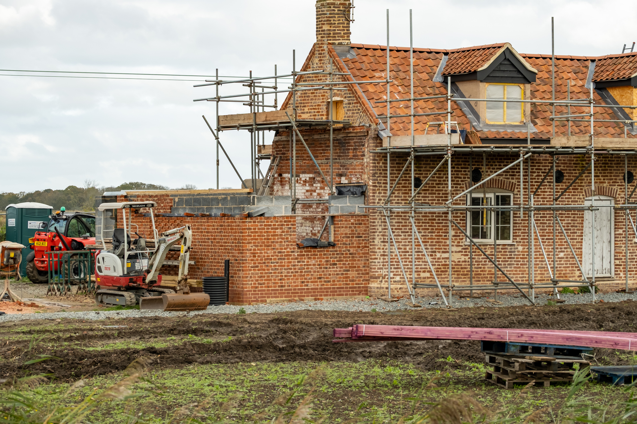 House with scaffolding undergoing building work