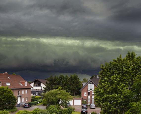 Photo of stormy skys over houses and trees
