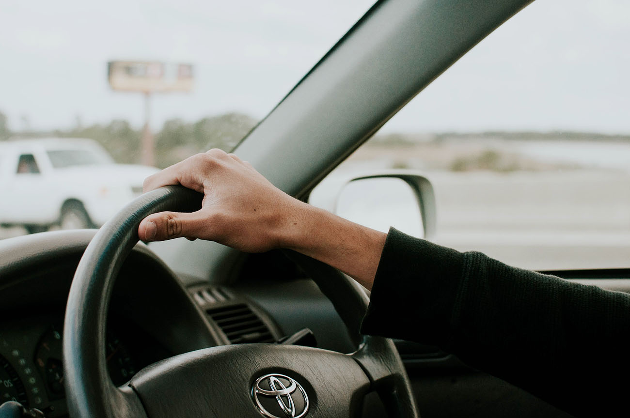 Man holding Toyota Prius steering wheel