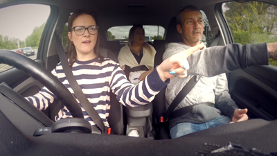 father and daughter driving looking for road signs