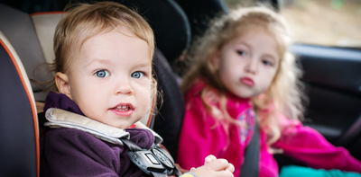 toddler and young child sat in car seats