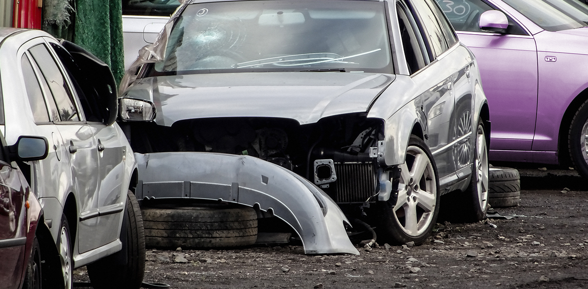 damaged car with bumper missing in scrapyard