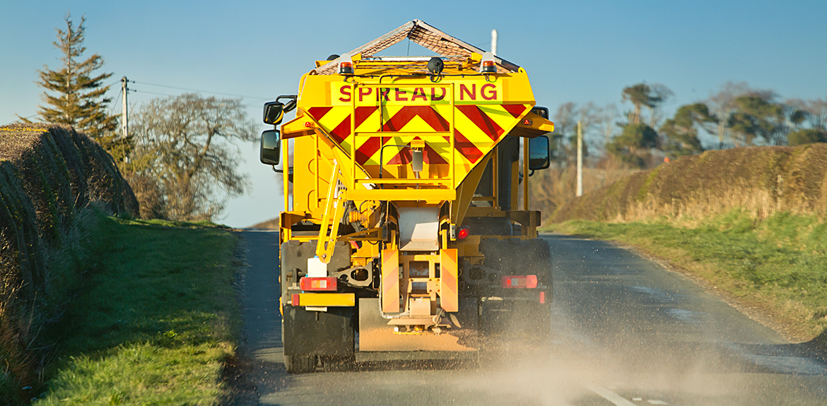 gritter spreading grit mixture on UK road
