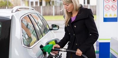 Woman putting fuel into her car