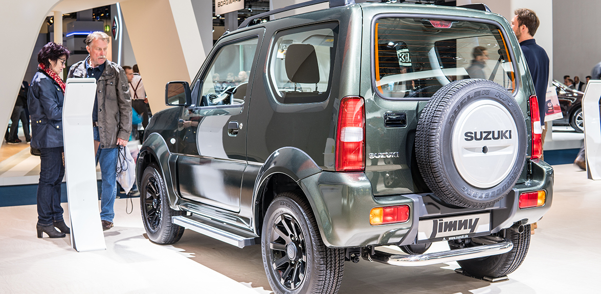 man and woman looking at suzuki jimny showroom