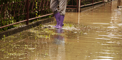 person wearing wellies wading through floodwater