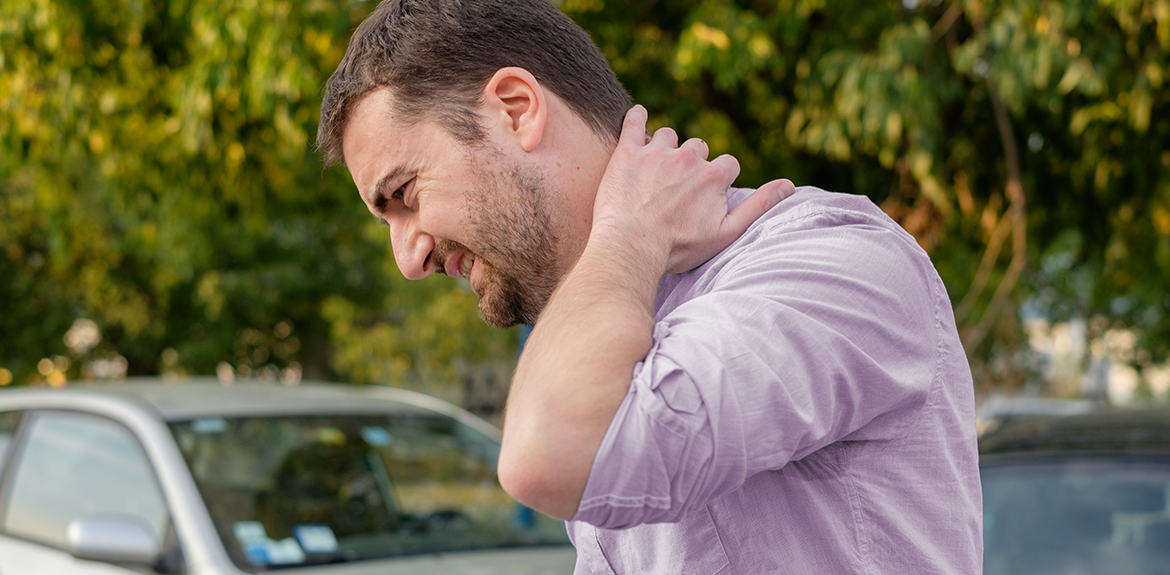 man holding neck in pain after car accident