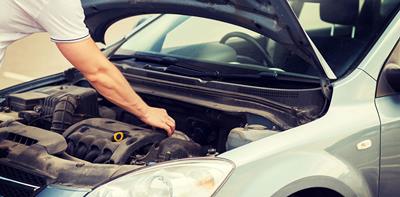 man checking car engine bonnet