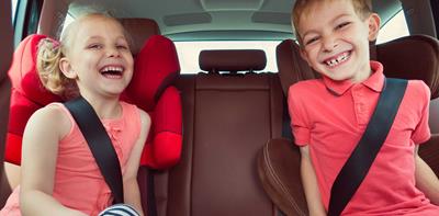 laughing boy girl in car seats