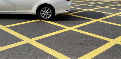 a car stopped in a yellow box junction