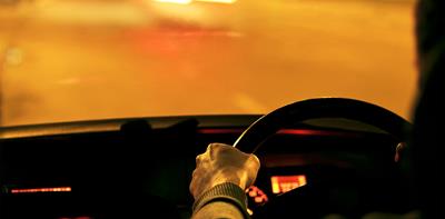 driver in car at night under street lights