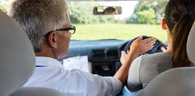 Man driving instructor car girl learning