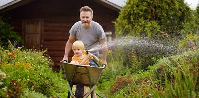 man boy wheelbarrow garden