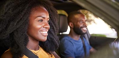 smiling woman driving car