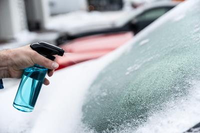 de-icer spraying a car window