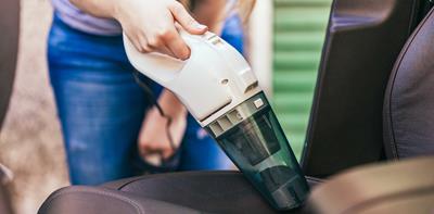 woman cleaning car vacuum hoover