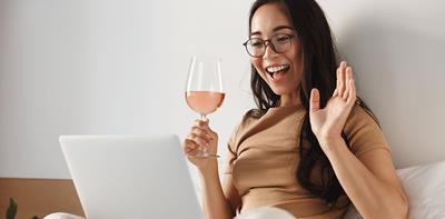 woman drinking wine near laptop