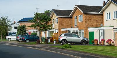 cars parked residential street houses garages