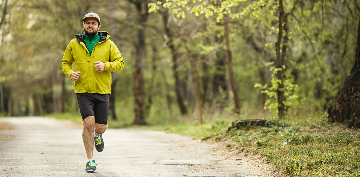 man running jogging yellow jacket shorts cap