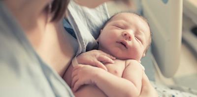 mother holding new baby