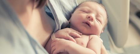 mother holding new baby