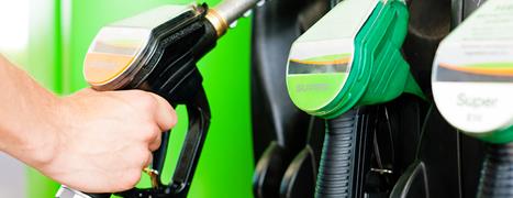 Driver picking up pump nozzle at a petrol station