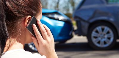 man inspecting car damage following a car accident