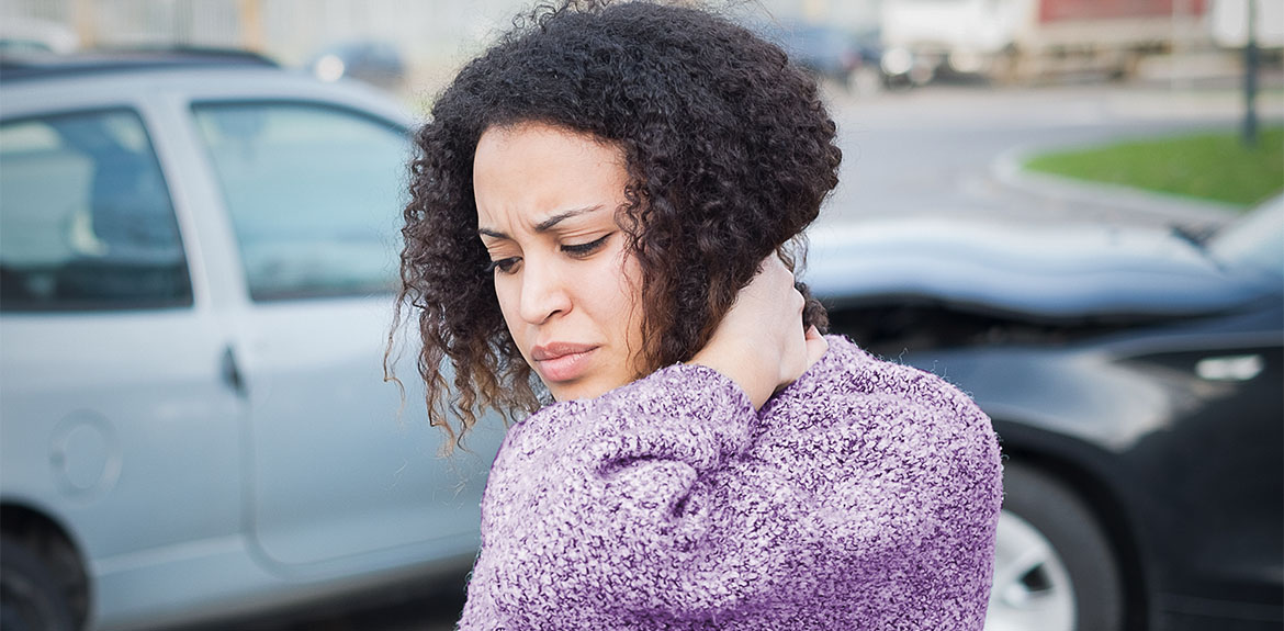 woman holding neck in pain following car accident