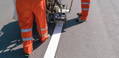white line markings on road being painted